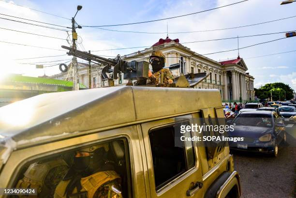 Soldier is seen on an armored vehicle during a search operation for gang members in street markets, plazas and public transportation. The army...