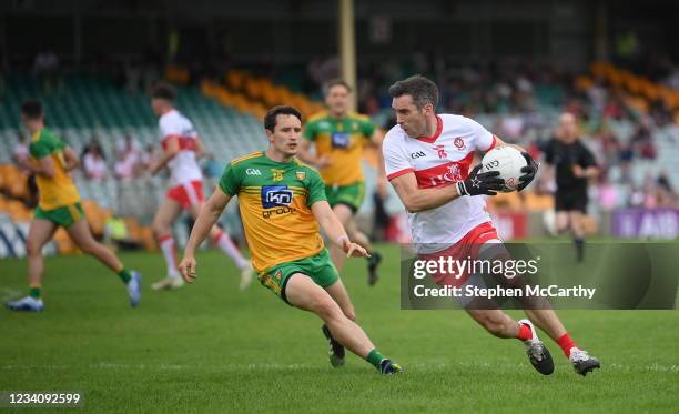 Donegal , Ireland - 11 July 2021; Benny Heron of Derry in action against Eoin McHugh of Donegal during the Ulster GAA Football Senior Championship...