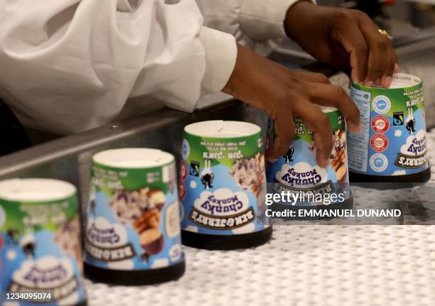 Labourer works on a production line filling ice-cream pots at the Ben & Jerry's factory in Be'er Tuvia in southern Israel, on July 21, 2021. - Ben &...