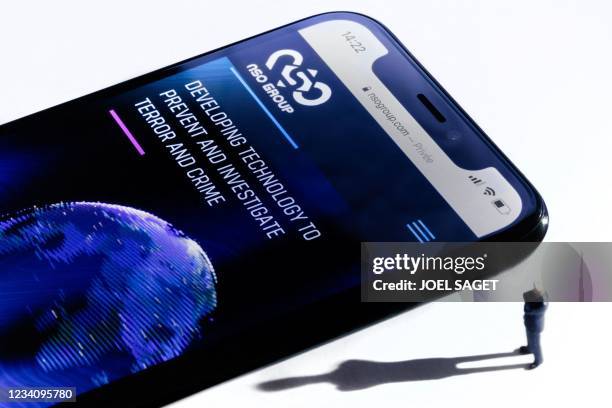 This studio photographic illustration shows a smartphone with the website of Israel's NSO Group which features 'Pegasus' spyware, on display in Paris...