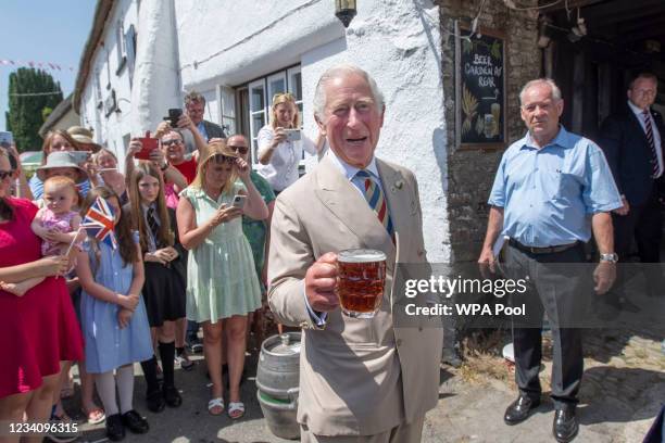 Prince Charles, Prince of Wales, drinks a pint of Bayes Topsail as he and Camilla, Duchess of Cornwall visit the Duke of York Public House in Devon...