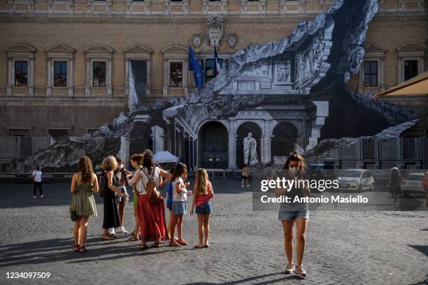 General view shows the art installation "Punto di Fuga" by the French contemporary artist JR, on the facade of Palazzo Farnese, on July 21, 2021 in...