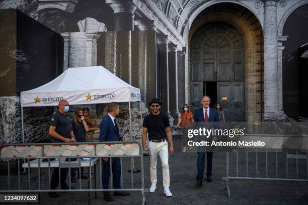 French contemporary artist JR and French Ambassador to Italy Christian Masset speak to the media in front of the art installation "Punto di Fuga" on...