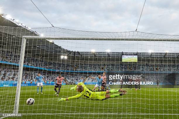 Helsinki's Swedish goalkeeper Jakob Tannander lets the 2-1 goal in for Malmo scored by Malmo's Danish midfielder Anders Christiansen during the UEFA...