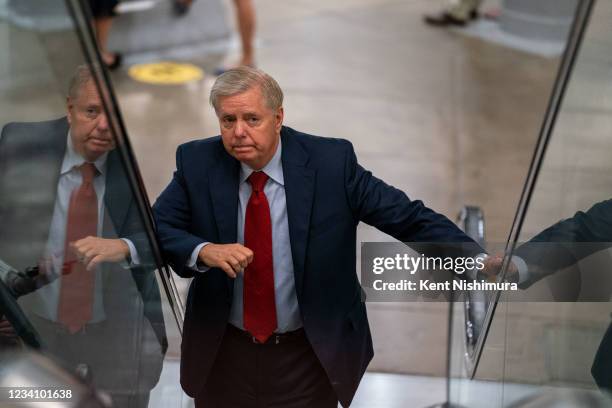 Sen. Lindsey Graham answers questions from reporters while on his way to a vote on Capitol Hill on Wednesday, July 21, 2021.