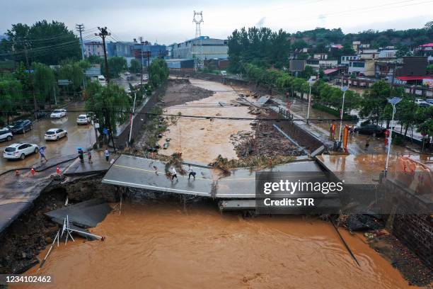 This aerial photo taken on July 21, 2021 show a damaged bridge following heavy rains which caused severe flooding in Gongyi in China's central Henan...