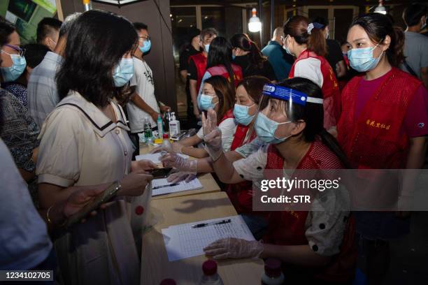 This photo taken on July 21, 2021 shows a resident preparing to receive a nucleic acid test for the Covid-19 coronavirus in Nanjing, in eastern...