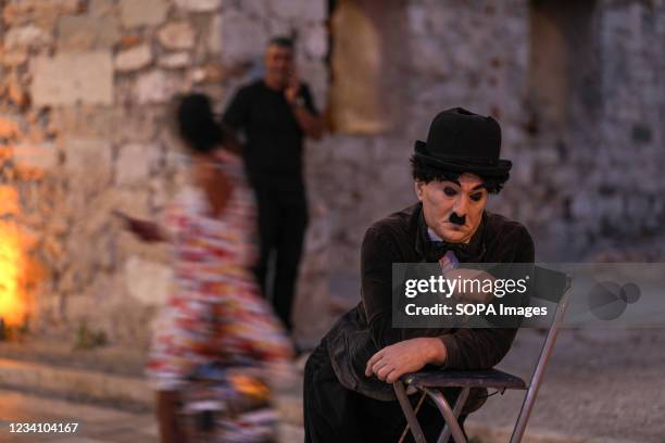 Street artist is playing the Charlie Chaplin character at Bodrum city center. One of most popular touristic districts of Turkey, Bodrum municipal of...