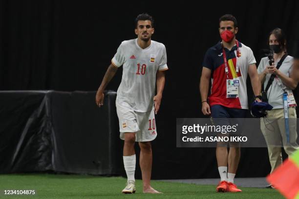 Spain's midfielder Dani Ceballos looks on from the sidelines after an injury during the Tokyo 2020 Olympic Games men's group C first round football...