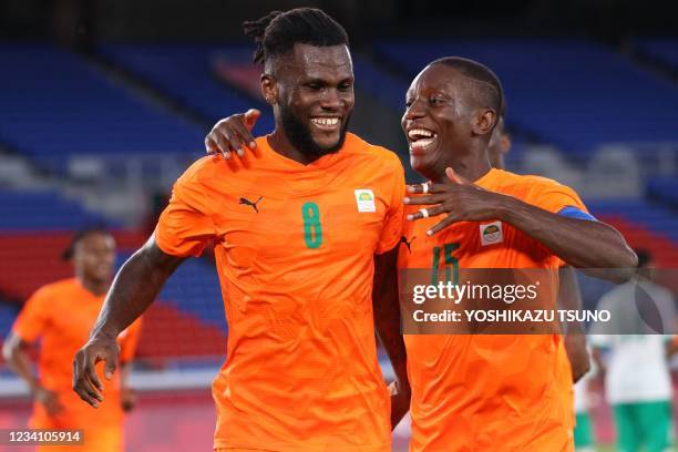 Ivory Coast's midfielder Franck Kessie celebrates with Ivory Coast's forward Max Gradel after he scored his side's second goal during the Tokyo 2020...