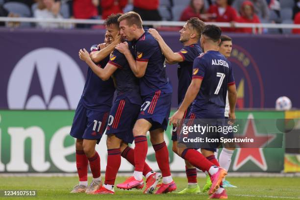 Chicago Fire midfielder Gaston Gimenez celebrates with fans and teammates after scoring a goal in action during a game between the Chicago Fire and...