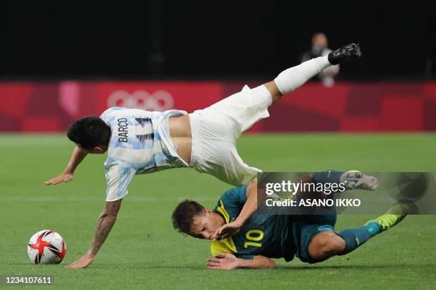 Australia's midfielder Denis Genreau and Argentina's midfielder Esequiel Barco fall over after a challenge during the Tokyo 2020 Olympic Games men's...