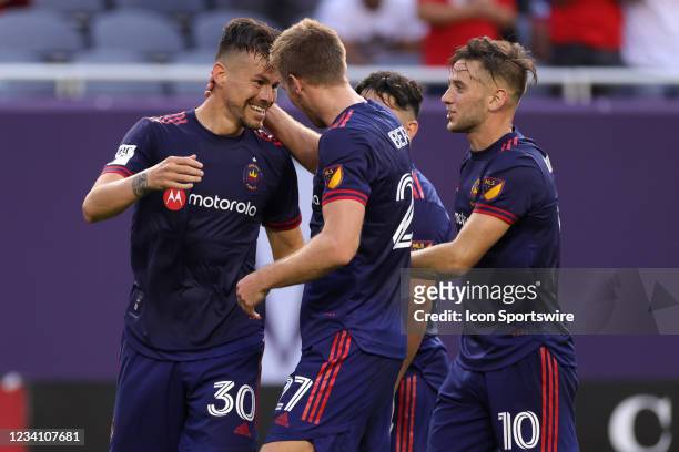 Chicago Fire midfielder Gaston Gimenez celebrates with fans and teammates after scoring a goal in action during a game between the Chicago Fire and...