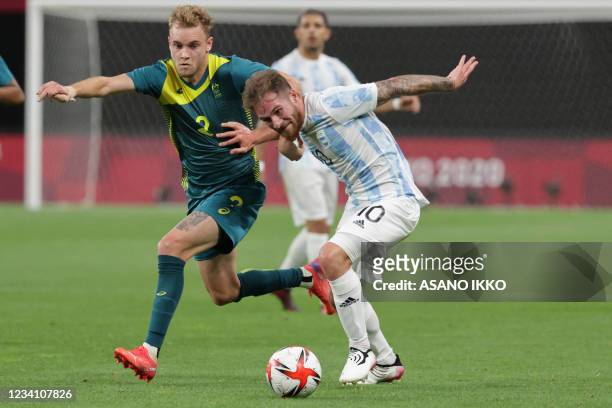 Australia's defender Nathaniel Atkinson competes for the ball with Argentina's midfielder Alexis Mac Allister during the Tokyo 2020 Olympic Games...