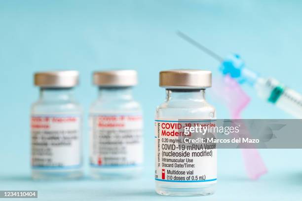 In this photo illustration vials of Moderna vaccine with a syringe for coronavirus treatment. Spain has exceeded 50% of the population vaccinated...