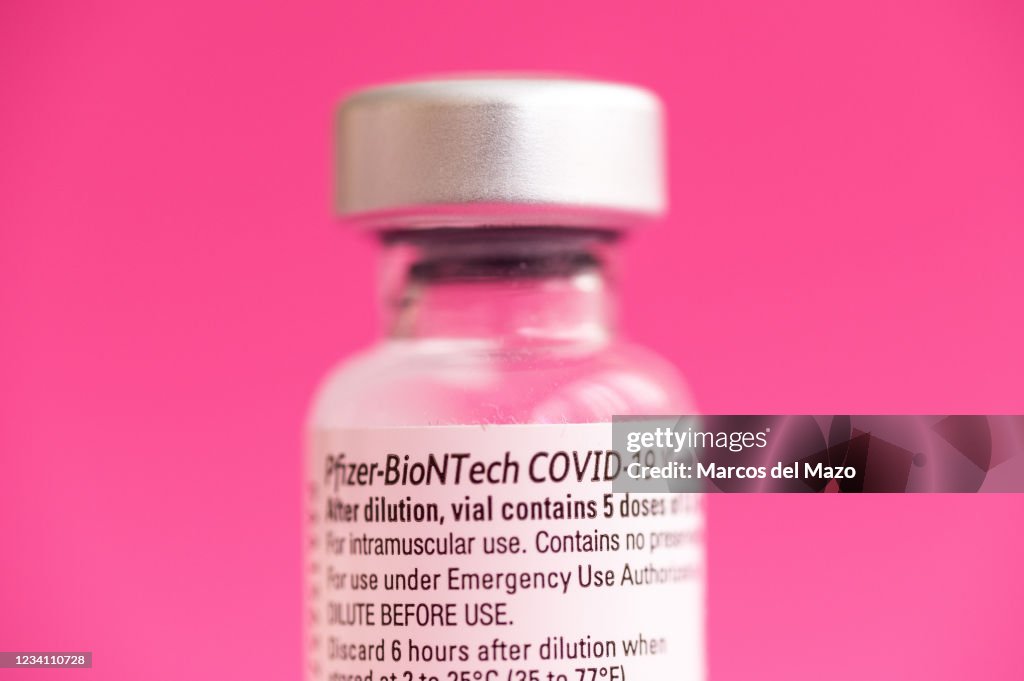 In this photo illustration a vial of Pfizer BioNTech vaccine...