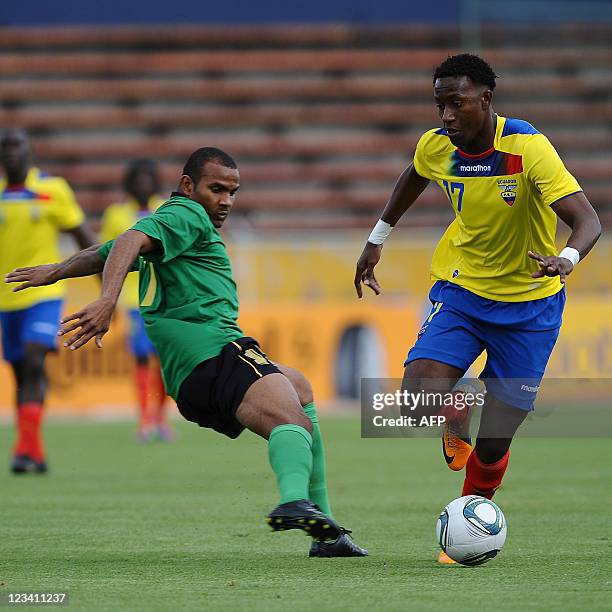 Ecuadorean Jaime Ayovi vies for the ball against Jamaica's Demar Phillips during a friendly soccer match at Atahualpa stadium in Quito, Ecuador on...