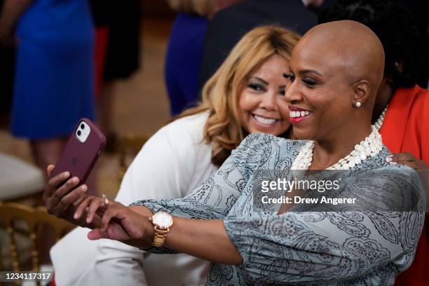 Rep. Lucy McBath takes a picture with U.S. Rep. Ayanna Pressley before U.S. President Joe Biden signs the VOCA Fix to Sustain the Crime Victims Fund...