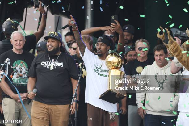 Former NBA Player, Brandon Jennings looks on with the Larry O'Brien Trophy during their Victory Parade & Rally of the 2021 NBA Finals on July 22,...