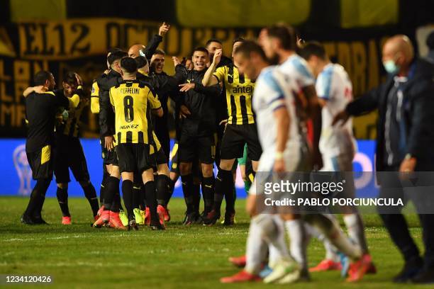 Penarol's players celebrate at the end their all-Uruguayan Copa Sudamericana round of 16 second leg derby football match against Nacional at the...