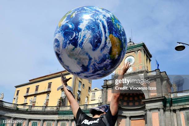 Protester with a balloon representing the planet Earth, during the demonstration against the G20 and raising concerns about environment issues which...