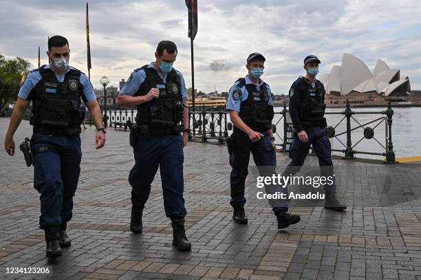 Police walk past the Sydney Opera House in Circular Quay, during lockdown in Sydney, Australia, Friday, July 23, 2021. NSW's top doctor has declared...