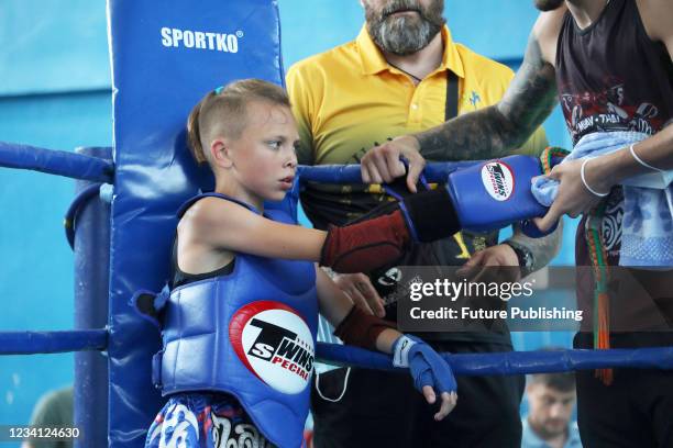 Boy gets his glove fixed in the corner of the ring during the Muay Thai Championship of Ukraine in Odesa, southern Ukraine.