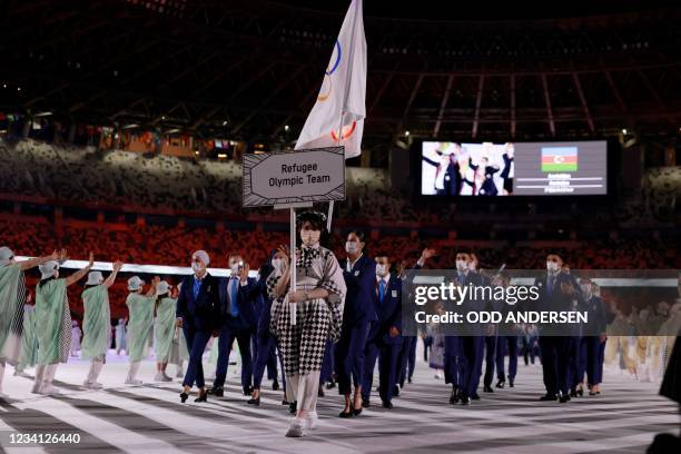 Members of the Refugee Olympic Team parade during the opening ceremony of the Tokyo 2020 Olympic Games, at the Olympic Stadium, in Tokyo, on July 23,...
