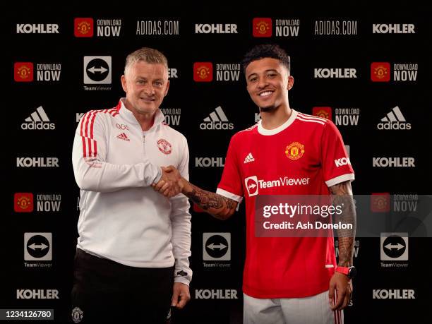 Jadon Sancho of Manchester United shakes hands with Manchester United Head Coach / Manager Ole Gunnar Solskjaer at Carrington Training Ground on July...