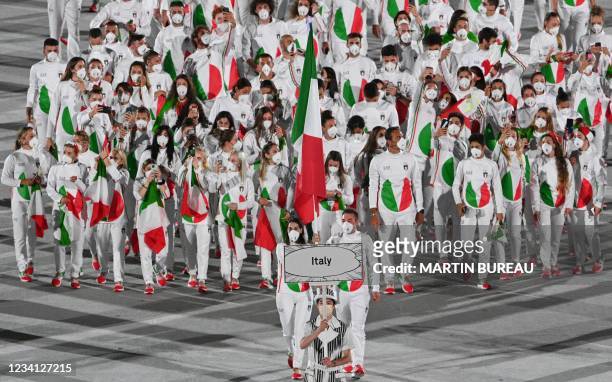 Italy's flag bearer Jessica Rossi and Italy's flag bearer Elia Viviani lead the delegation during the opening ceremony of the Tokyo 2020 Olympic...