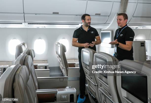 Staff members introduce cabin facilities of an Airbus A350 aircraft delivered to China Eastern Airlines at the Airbus Tianjin Widebody Completion and...