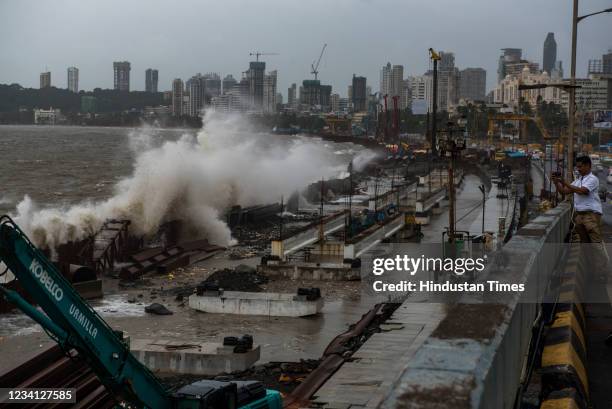 Sea waves crash ashore during high tide at Marine Drive, on July 22, 2021 in Mumbai, India.