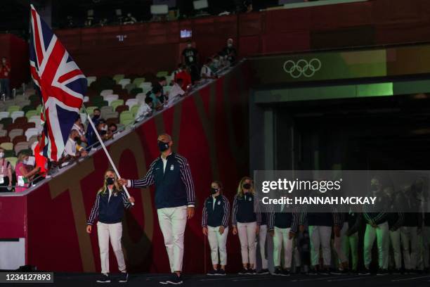 Britain's flag bearers Hannah Mills and Mohamed Sbihi lead the delegation during the Tokyo 2020 Olympic Games opening ceremony's parade of athletes,...