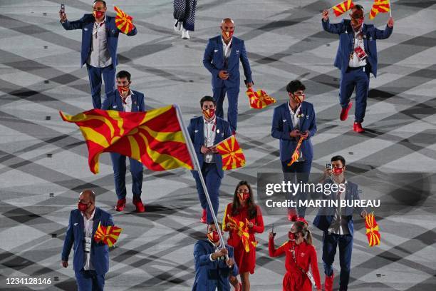 North Macedonia's flag bearer Dejan Georgievski and North Macedonia's flag bearer Arbresha Rexhepi lead the delegation during the opening ceremony of...