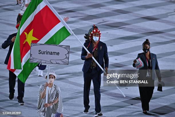 Suriname's flag bearer Renzo Tjon-A-Joe leads the delegation during the opening ceremony of the Tokyo 2020 Olympic Games, at the Olympic Stadium, in...
