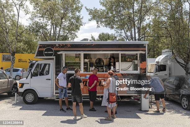 Visitors wait for refreshments at the mobile food van on the Hollywood movie set of "The Enforcer" during a media day at the German School in...