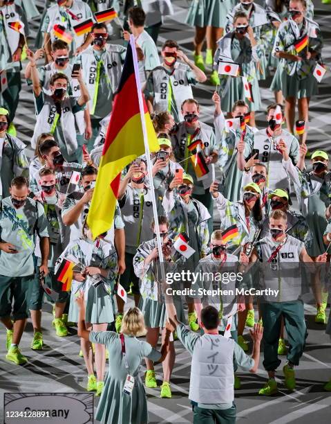Tokyo , Japan - 23 July 2021; Team Germany flagbearers Laura Ludwig and Patrick Hausding carry the German flag during the 2020 Tokyo Summer Olympic...
