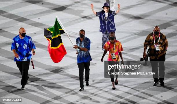Tokyo , Japan - 23 July 2021; Team Saint Kitts and Nevis flagbearers Amya Clarke and Jason Rogers carry the Saint Kitts and Nevis flag during the...