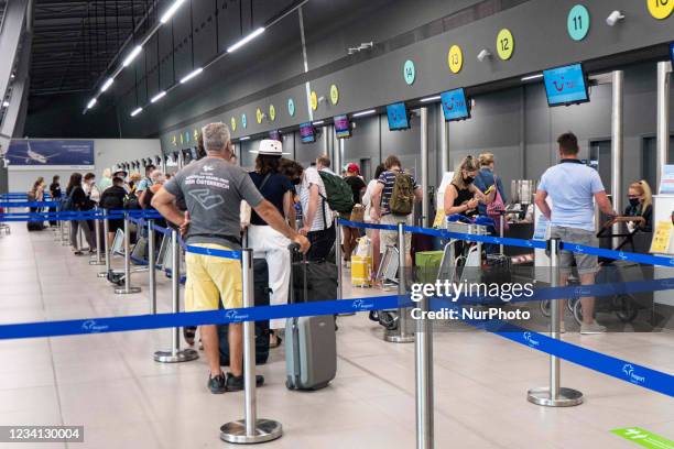 People in the departure hall of new T2 with the check in desks at Thessaloniki International Airport Makedonia SKG LGTS in Northern Greece....
