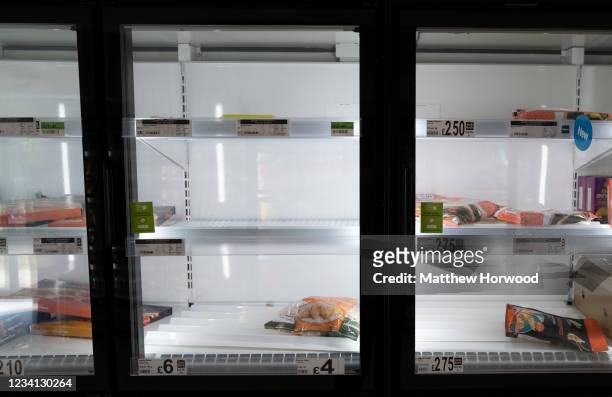 Low stock in a freezer in a Morrisons store on July 23, 2021 in Cardiff, United Kingdom. Supermarkets across the UK are emptying of fresh produce and...