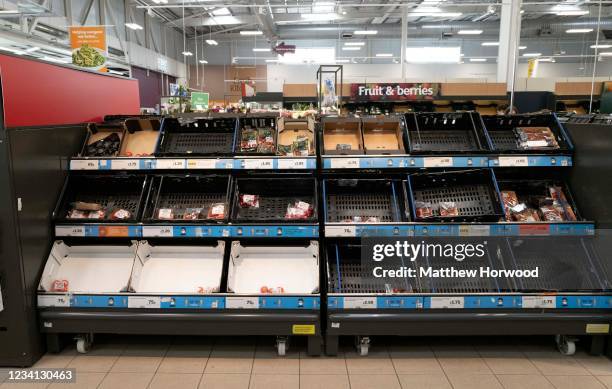 Shelves low on tomatoes in a Sainsburys store on July 23, 2021 in Cardiff, United Kingdom. Supermarkets across the UK are emptying of fresh produce...