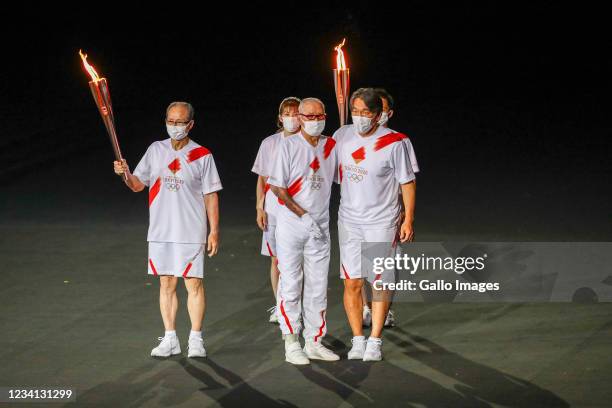 Shigeo Nagashima, Hideki Matsui and Sadaharu Oh carry the Olympic flame during the Tokyo 2020 Olympic Games Opening Ceremony at Olympic Stadium on...