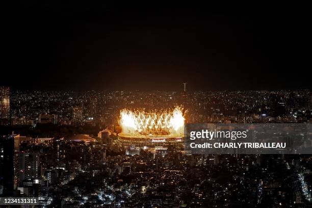Fireworks light up the sky over the Olympic Stadium during the opening ceremony of the Tokyo 2020 Olympic Games, in Tokyo, on July 23, 2021.