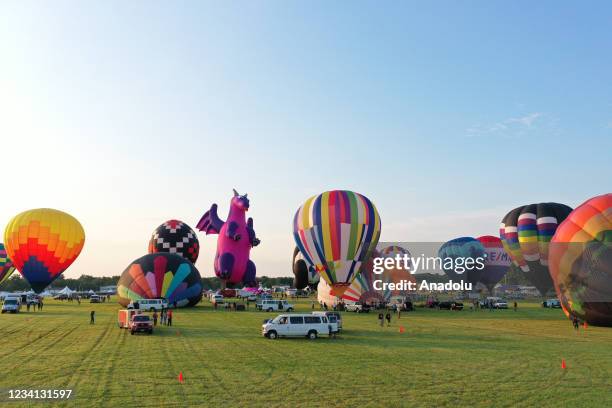 Hot air balloons fly across the sky during The 38th Annual New Jersey Lottery Festival of Ballooning on July 23, 2021 in Readington, New Jersey.