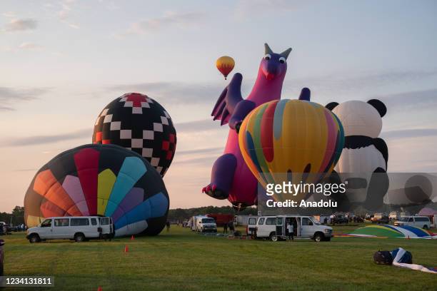 Hot air balloons fly across the sky during The 38th Annual New Jersey Lottery Festival of Ballooning on July 23, 2021 in Readington, New Jersey.
