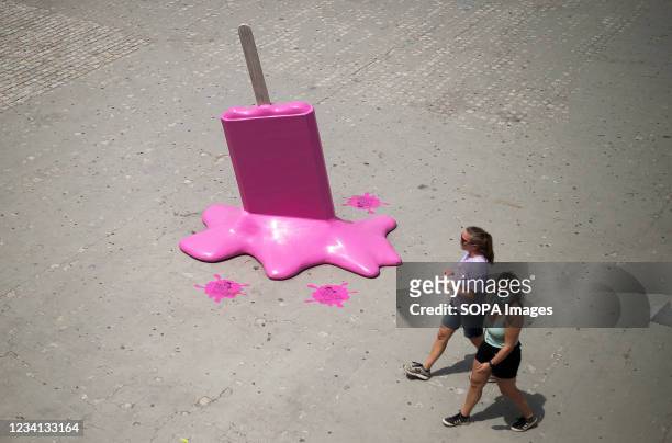 Women walk past an ice cream sculpture at the walk 'Muelle Uno' during a hot summer day amid coronavirus pandemic. The state weather agency AEMET...