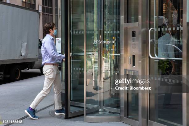 An office worker wearing a protective mask enters the JPMorgan Chase & Co. Headquarters in New York, U.S., on Thursday, July 22, 2021. After a year...