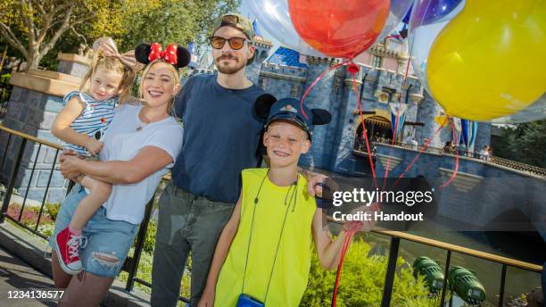 In this handout photo provided by Disneyland Resorts, Hilary Duff with her husband, singer-songwriter Matthew Koma, their daughter Banks and Duff's...