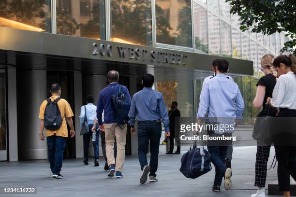 Office workers walk towards the Goldman Sachs Group Inc. Headquarters in New York, U.S., on Thursday, July 22, 2021. After a year of Zoom meetings...