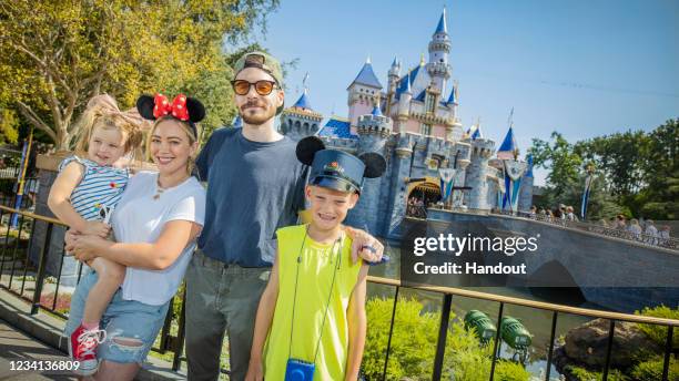 In this handout photo provided by Disneyland Resorts, Hilary Duff with her husband, singer-songwriter Matthew Koma, their daughter Banks and Duff's...